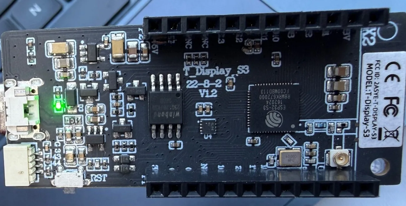 Back of the LilyGO T-Display S3 showing the ESP32-S3 chip, the Winbond flash chip and the T-Display-S3 label with the FCC ID